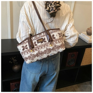 Detailed view of plush lamb wool tote bag with retro contrast patterns and leather straps