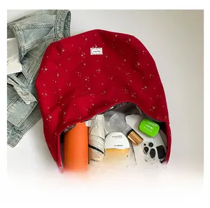 Top view of large red canvas star tote bag showing spacious interior with daily essentials