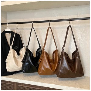 Selection of large faux leather hobo bags in cream, black, and brown with adjustable straps