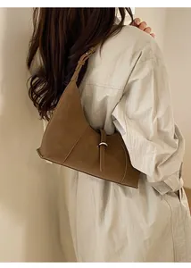 Detail of caramel hobo bag featuring premium leather texture and silver metal buckle