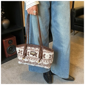 Detail of plush wool tote bag with brown leather straps and vintage patterned texture