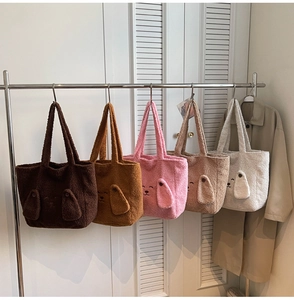 Detailed view of five colorful plush teddy tote bags with 3D animal ears and embroidery
