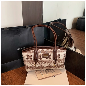 Detail of vintage wool tote bag with geometric patterns and brown leather strap