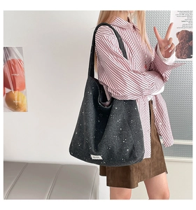 Detail of dark grey star-patterned tote bag showing large capacity and soft felt texture