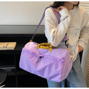 Detail of purple fitness bag with yellow handles and check pattern drawstring pocket