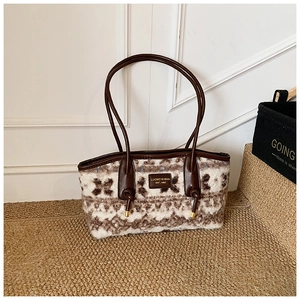 Detailed view of plush jacquard tote bag with brown leather straps and vintage pattern