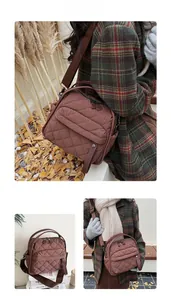 Close-up of brown quilted nylon tote bag with wide shoulder strap and dual zipper detail