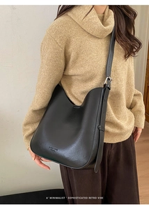 Close-up of black leather Hobo bag showing textured surface and adjustable silver buckle