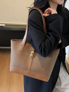 Dark brown pebble leather tote bag with wide strap and gold twist lock for daily commute