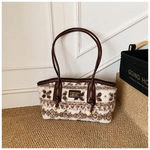 Close-up of vintage wool tote bag with leather strap and decorative drawstring details