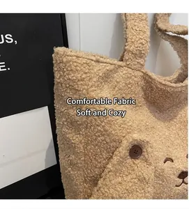 Close-up of soft plush beige tote bag featuring cute teddy bear face and fleece texture