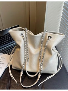 High-capacity cream white chain tote bag for women shown with laptop and books