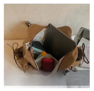 Internal storage view of brown tote bag showing capacity for tablets and daily items