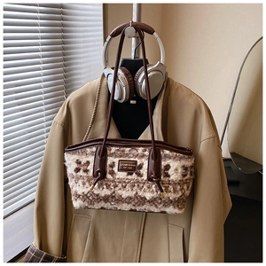 Detail of wool tote bag with brown leather handles and vintage floral texture
