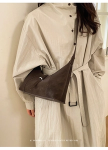 Deep brown matte leather hobo bag styled with a minimalist beige dress on a model