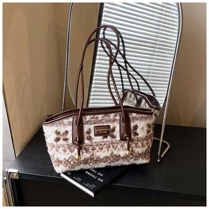 Close-up of vintage woolen tote bag with geometric pattern and brown leather straps