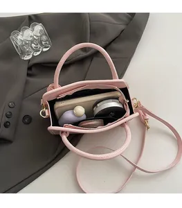 Internal view of pink mini crossbody bag showing storage space for phone and makeup