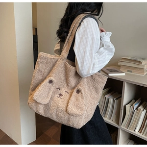 Detail of cute plush tote bag featuring 3D animal ears and cozy faux shearling texture