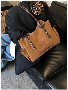Detail of Cute Puppy embroidery and metal rivets on brown oversized shoulder tote bag