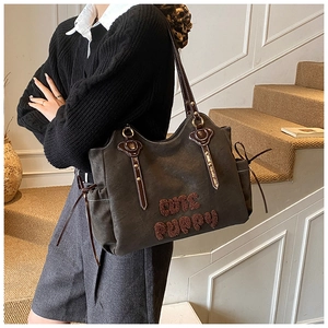 Detail of dark brown matte tote bag with cute puppy embroidery and drawstring side pockets