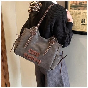 Detail of grey tote bag with Cute Puppy embroidery and brown faux fur lettering