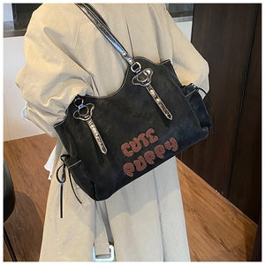 Detailed view of Cute Puppy plush lettering and side drawstring on large black tote bag