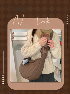 Detailed wave quilted texture on a large tan cotton crossbody hobo bag for winter