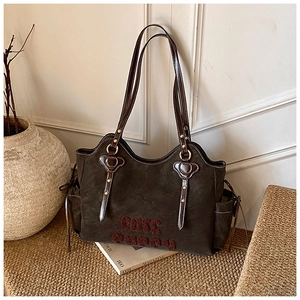 Detail of vintage dark brown tote bag with flocked CUTE PUPPY lettering and side drawstring