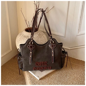 Detailed view of the Cute Puppy tote bag with plush lettering and heart-shaped rivet accents
