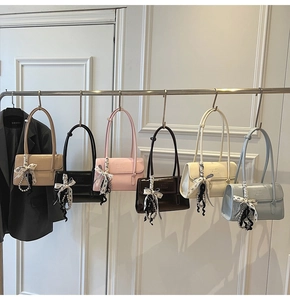 Detailed view of square flap shoulder bags in six colors with bows and pearl charms