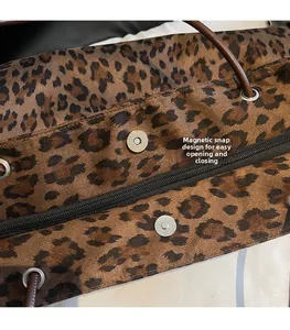 Detail view of leopard print tote bag showing secure magnetic snap and zipper closure
