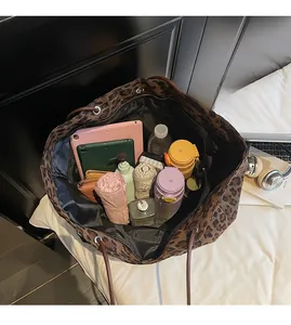Top view showing large capacity leopard print tote bag with multiple daily items inside