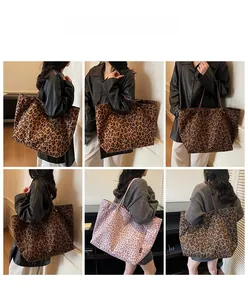 Detail view of large leopard print tote bags in various colors on a model for daily use
