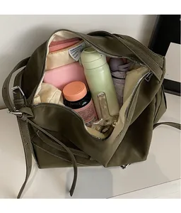 Olive green suede tote bag showing large capacity for water bottle, umbrella and wallet