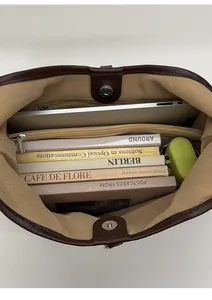 Internal view of spacious tote bag showing laptop, books and zipped compartment