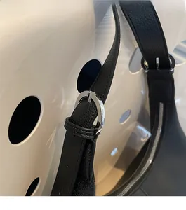 Detail of silver metallic buckle and premium lychee texture on black leather bag