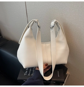 Detail view of white lychee grain leather hobo bag with polished silver metal rings