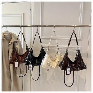 Detail of four retro glossy leather tote bags with pleated texture and adjustable straps