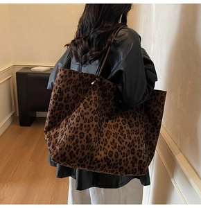 Macro detail of large leopard print tote bag with premium leather handles and texture