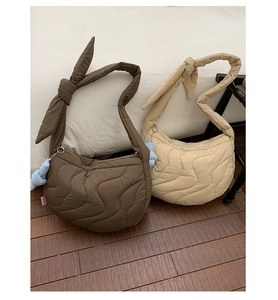 Quilted wave pattern details on soft padded crescent bags with decorative bow strap knots