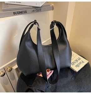 Detail of black lychee grain leather hobo bag featuring silver ring buckle hardware