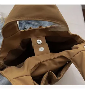 Close-up of brown tote bag interior featuring magnetic closure and premium hardware