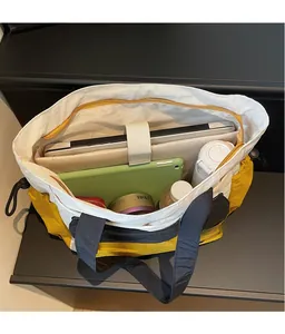 Interior view of tote bag showing laptop compartment and spacious storage compartments