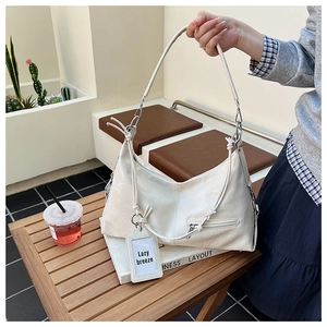 Detail of cream hobo bag featuring retro wrinkled leather and lazy breeze charm