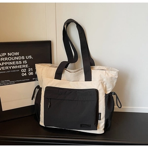 Minimalist large contrast color tote bag with front pocket and drawstring side detail