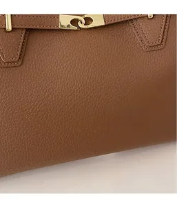 Detail of brown litchi pattern leather tote with premium gold metal clasp and stitching
