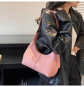 Detail of pink hobo bag featuring premium lychee grain leather and adjustable strap