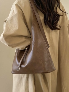Deep brown matte leather tote bag with unique triangle stitching and metal ring detail