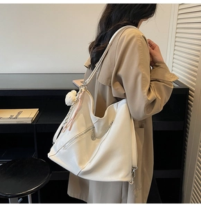 Vue détaillée du grand sac cabas blanc en cuir PU avec charm pompon et poche zippée moderne