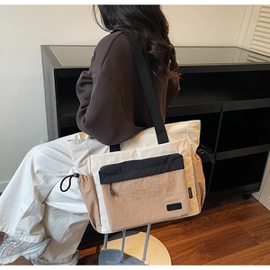 Detail showing side view of contrast tote bag with adjustable black shoulder strap